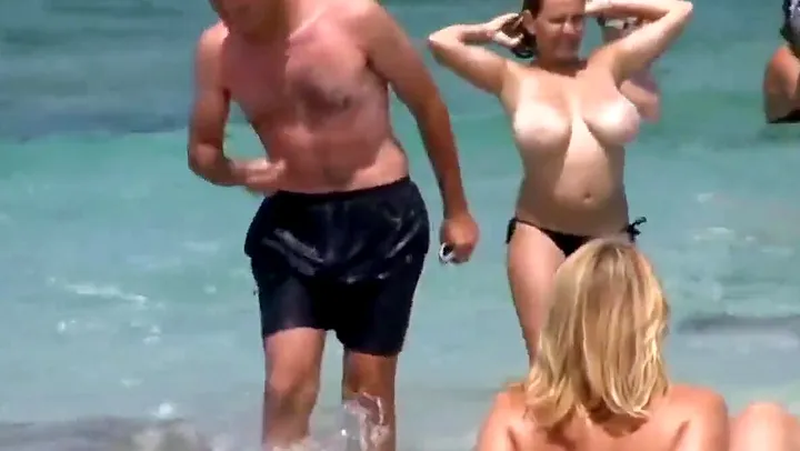 divorced busty milf walking on the public beach with no bra